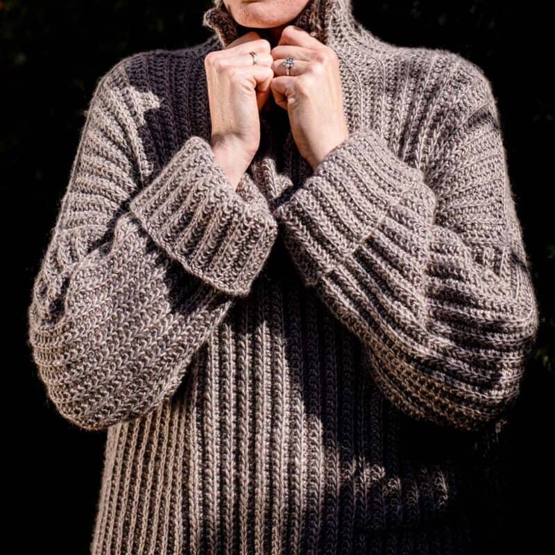 Strickjacke aus Wolle, perfekt für kalte Tage, mit detailliertem Muster, getragen von einer Perso.